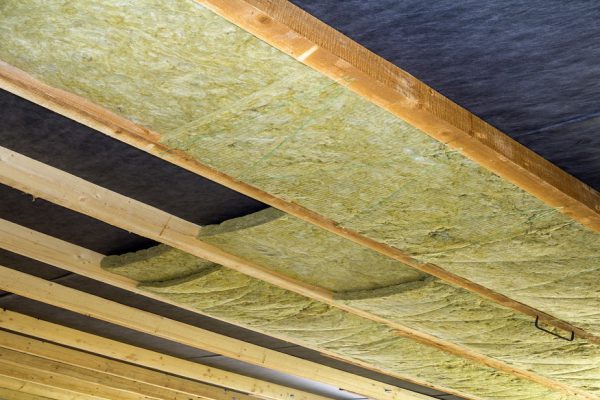Thermal insulation mineral rock wool installation at the new building attic ceiling